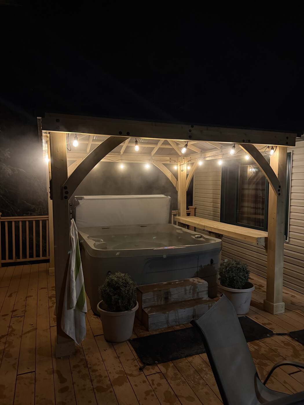 Covered hot tub on the deck at night